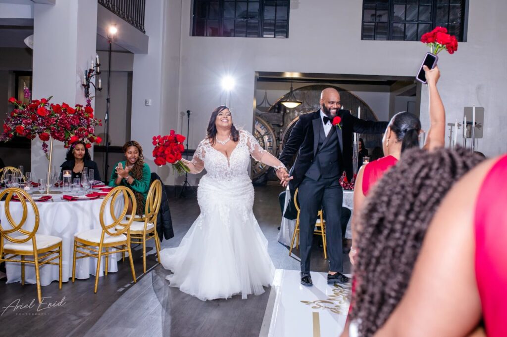 Bride and Groom Holding Hands Walking into Reception Venue